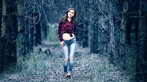 Girl Model Is Wearing Red Blue Top And Jeans Standing In Forest