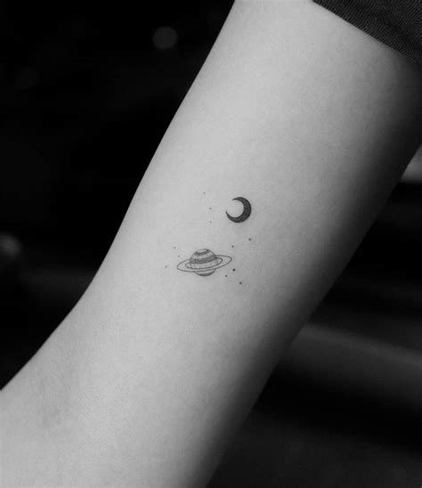 Small Single Needle Crescent And Saturn Tattoo On The