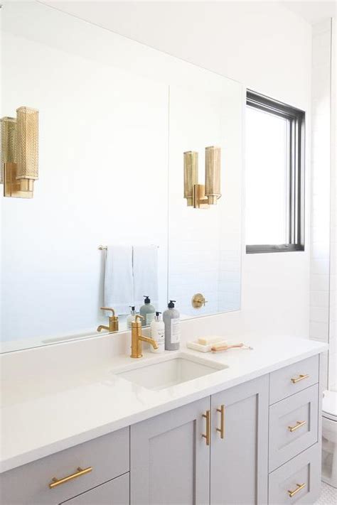 light gray washstand  brushed gold faucet