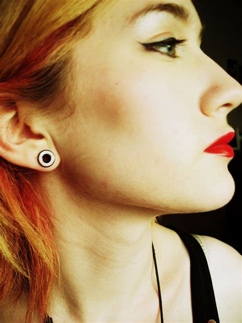 4g stretched ears with tunnels and red lipstick tunnels can be classy p piercing ideas