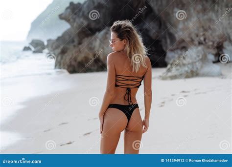 Backside View Of Girl With Booty In Black Bikini Resting On Deserted Beach Stock Photo Image