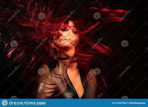 A Girl On A Black Background With Double Exposure With Red Hair In The