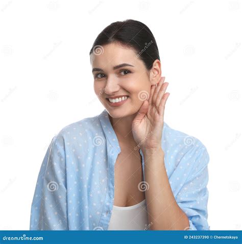 Young Woman Showing Hand To Ear Gesture On White Background Stock Photo