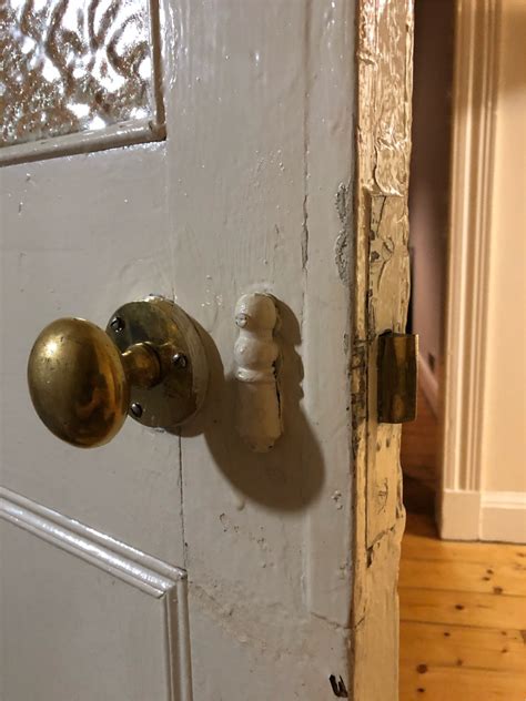 How do you tighten a lever door handle? doorknob - How to reattach door handle where wood behind ...