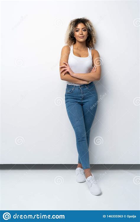 Full Length Portrait Of Stylish Young Black Woman Standing On White