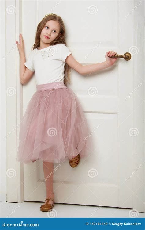 A Little Girl Is Standing By The Door Stock Photo Image Of Interior