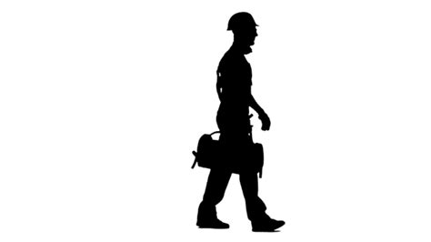 Silhouette Of Working Builder Goes To Work With A Suitcase With Tools