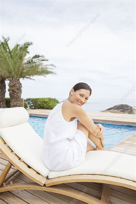 Woman Relaxing In Lawn Chair By Pool Stock Image F