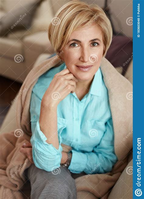 Mature Woman Beautiful Healthy Middle Age Female Sitting On Sofa At