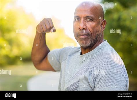 Man Flexing Muscle Black Hi Res Stock Photography And Images Alamy