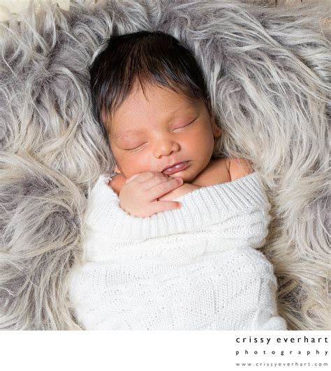 Newborn Boy On Faux Fur In Home Portrait Session