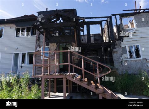 Rescuers firefighters extinguish a fire on the roof. The building after