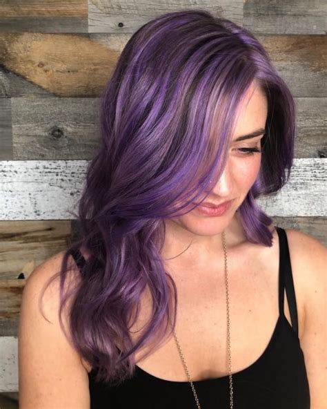 Electric purple highlights in brown hair. 22 Purple Highlights Trending in 2021 to Show Your Colorist