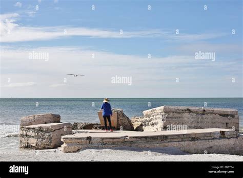 A Woman Standing On Crumbling Ruins At Fort De Soto Park In St