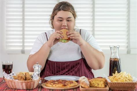 Asian Over Size Fat Woman Enjoy Eating On The Restaurant Stock Image