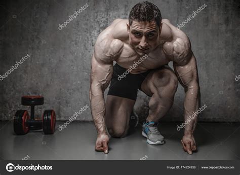 Handsome Model Young Man Posing In Gym — Stock Photo © Antondotsenko