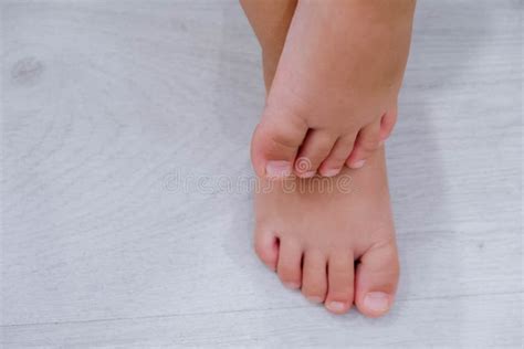 Children`s Bare Feet Child`s Bare Feet On The Wooden Floor Stock Image