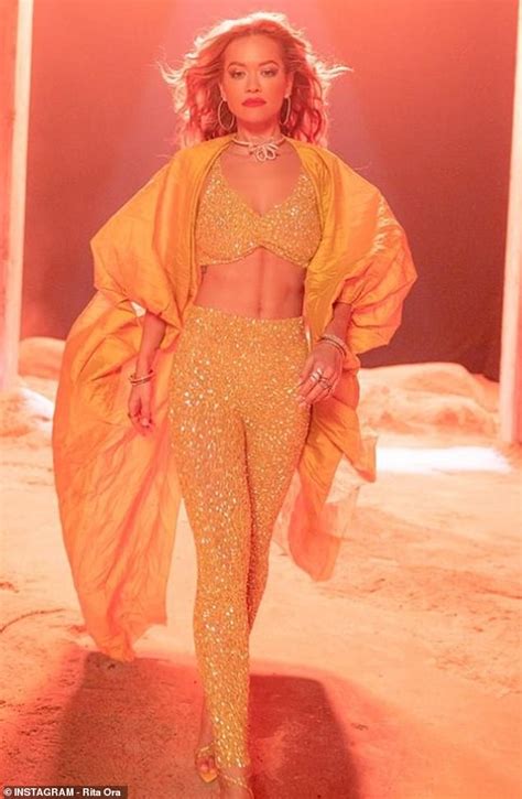 rita ora dazzles in a yellow sequin bra top as she shares behind the scenes transformation