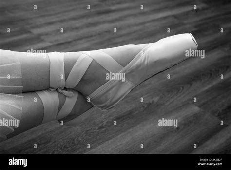 Female Ballerina Feet In Pointes On A Wooden Floor Closeup Monochrome