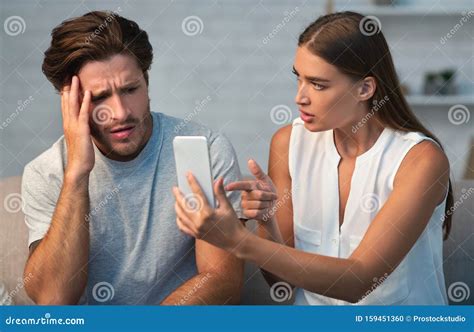Wife Showing Cheating Husband Cellphone Demanding Explanation At Home