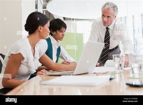 Project discussions amongst employees in boardroom Stock Photo - Alamy