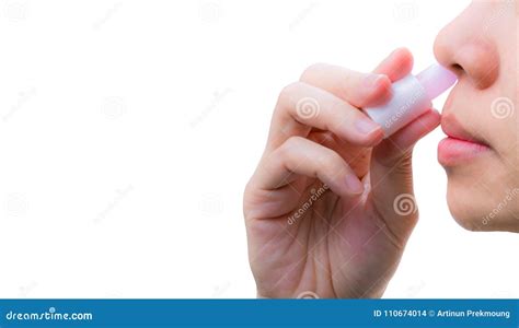 Asian Woman`s Hand Hold Nasal Inhaler And Inhale Through Nostril To
