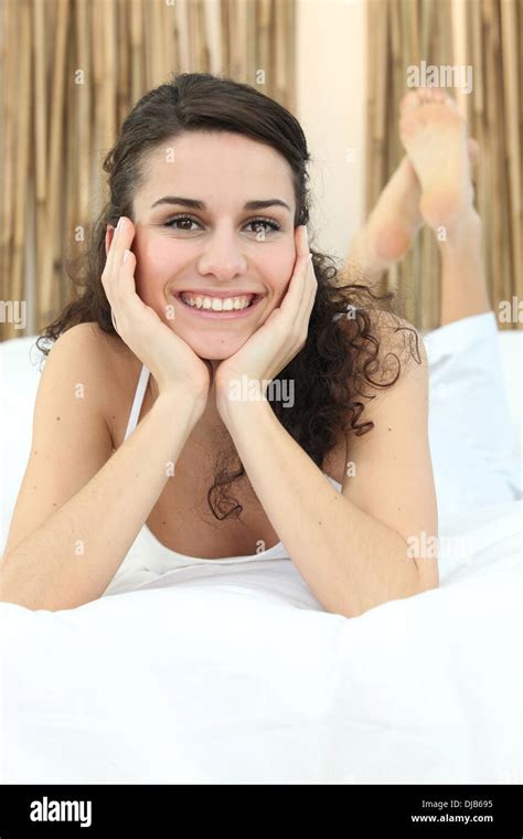 Attractive Woman Lying On Bed Stock Photo Alamy