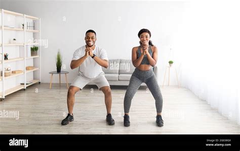 Domestic Strength Workout Motivated Black Lady And Her Male Partner