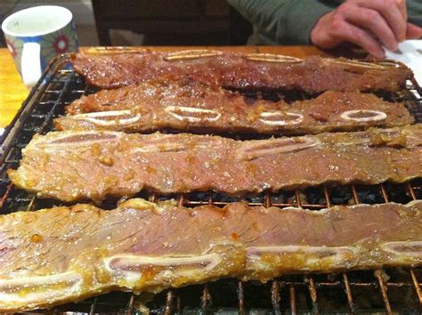 Ribs Are Cooking On The Grill And Being Grilled