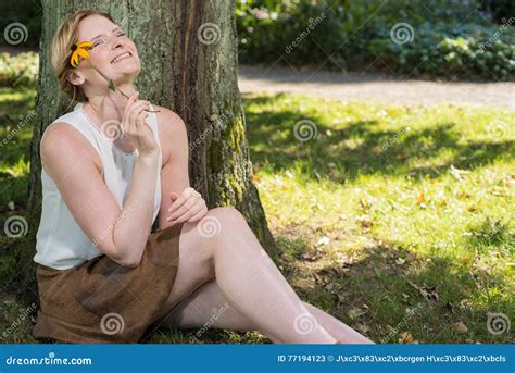 Beautiful Blonde Woman Is Sitting Near A Tree And Dreaming Stock Image Image Of Skirt