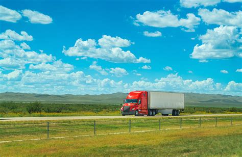 Red And White Semitruck Driving On The Highway Motion Blur Stock Photo
