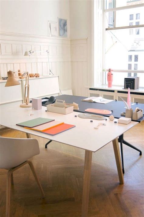 A White Table Sitting In Front Of A Window Filled With Lots Of Books