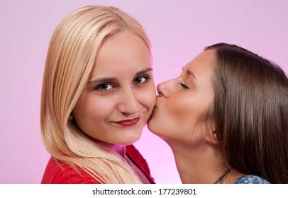 Brunette Kissing Another Blonde Girl On Stock Photo