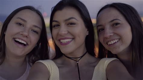 Closeup Of Carefree Teen Girls Making Funny Faces And Smiling For
