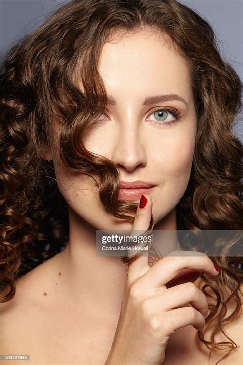 Female Model Twirling Hair Over Face Photo Getty Images