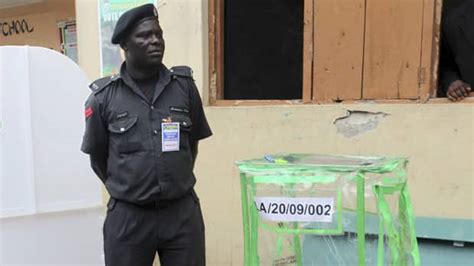A Policeman Stands Guard Near A Ballot Box At A Polling Unit Before The