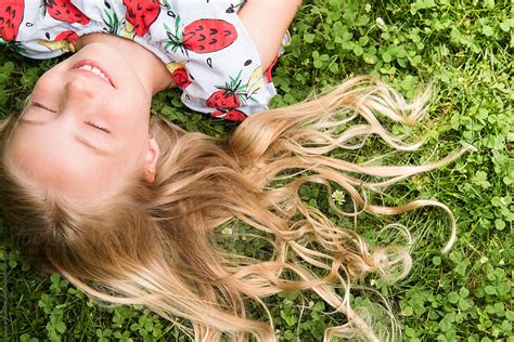 Close Up Of Girl Lying In Grass By Stocksy Contributor Jamie Grill Atlas Stocksy