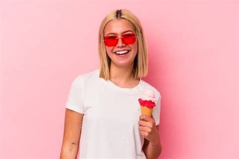 Premium Photo Young Venezuelan Woman Eating An Ice Cream Isolated On Pink Wall Laughing And