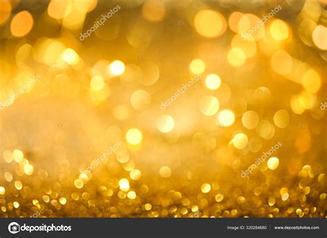 Abstract Bokeh Of Glowing Yellow Lights And Sparkling Gold Glitt