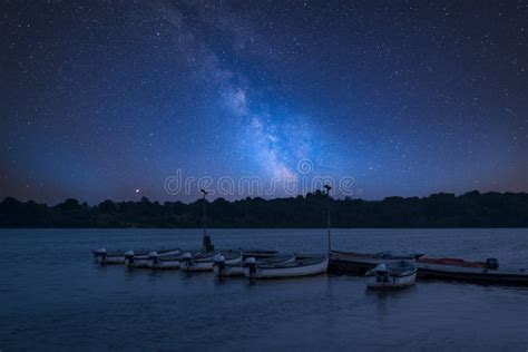 Vibrant Milky Way Composite Image Over Landscape Of Leisure Boat Stock