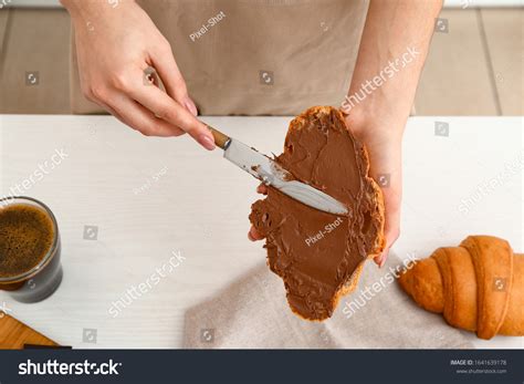 Woman Spreading Chocolate Onto Fresh Croissant Stock Photo Shutterstock