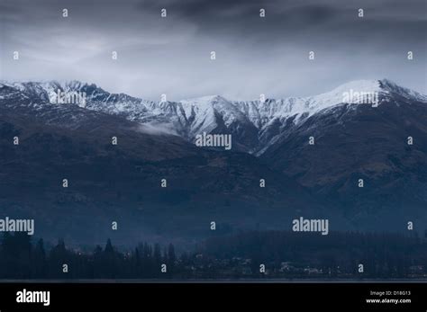 Clouds Gathering Over Snowy Mountains Stock Photo Alamy