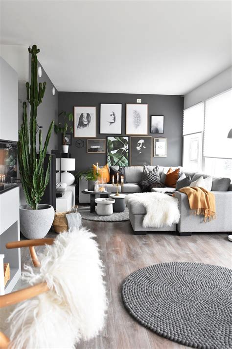 A Living Room Filled With Furniture And Pictures On The Wall