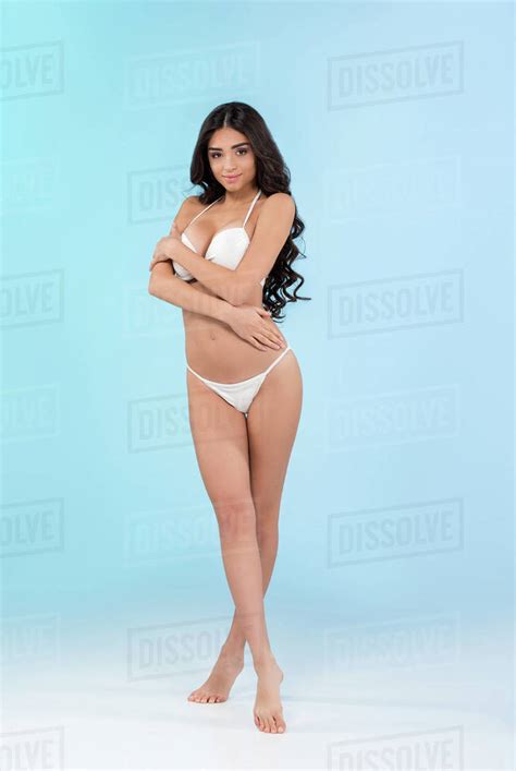 Beautiful Slim Girl In White Bikini Isolated On Blue Stock Photo Dissolve
