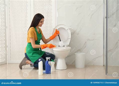 Young Woman Cleaning Toilet Bowl In Bathroom Stock Image Image Of