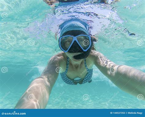 Woman Taking An Underwater Selfie While Snorkeling In Crystal Clear Tropical Water Stock Image