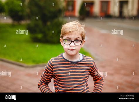 Strong Smart And Funny Little Boy Playing Outdoors Wearing Eyeglasses