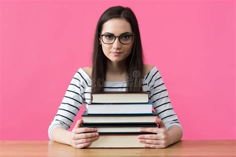 Happy Smiling Female Student Sitting At Her Desk With Textbooks Stock
