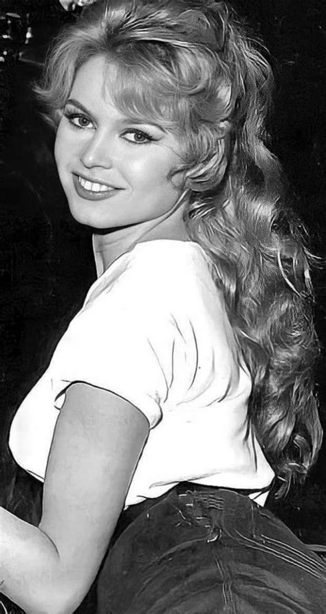 A Black And White Photo Of A Woman With Long Blonde Hair Wearing A T Shirt