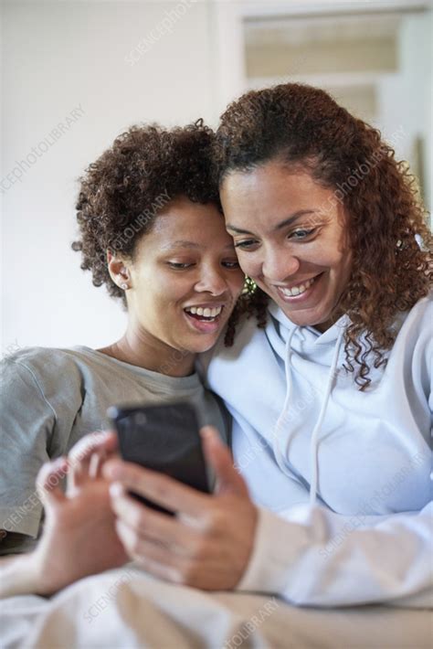 Happy Lesbian Couple Using Smart Phone Stock Image F037 9038 Science Photo Library